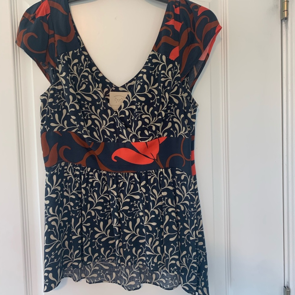 Orange and navy blouse.